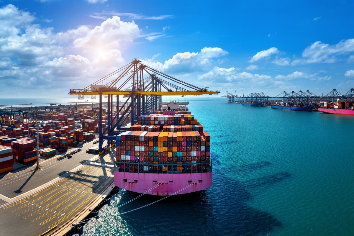 This is an image of a large container ship getting loaded at a port