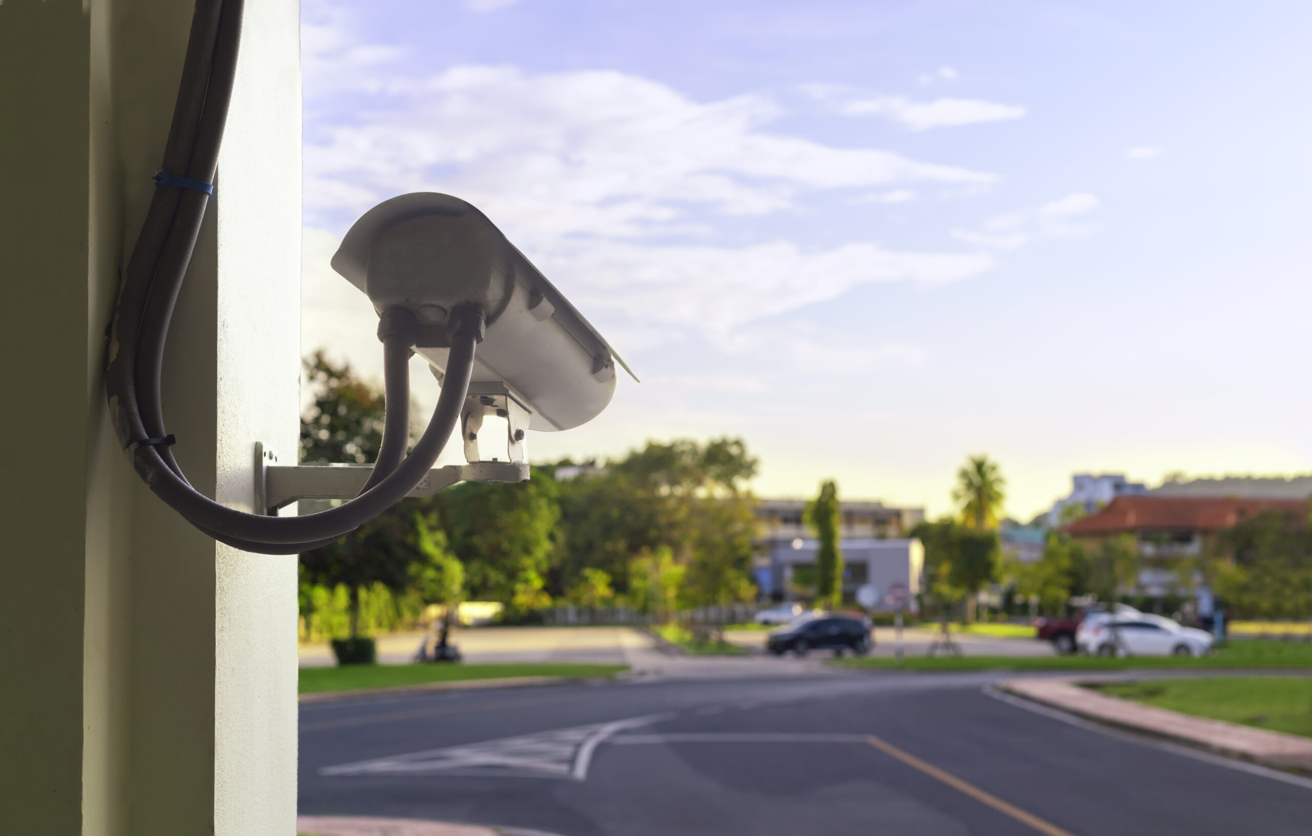CCTV camera security at outdoor parking lot. With copy space for An ALPR camera pointed towards an approach road as part of restaurant tech implementation