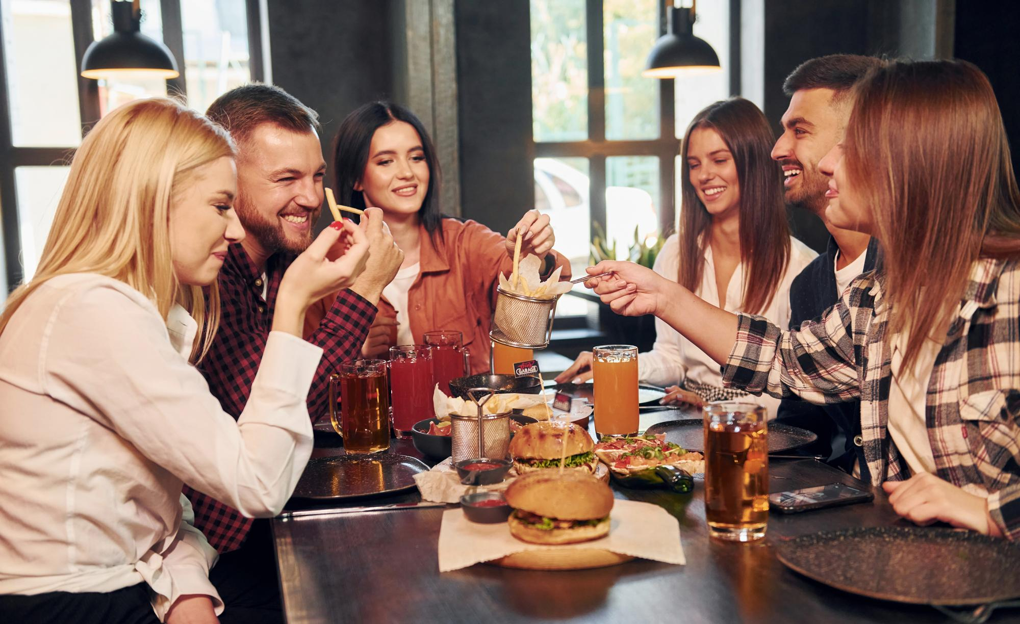 Group of friends eating at a fast food restaurant 1 A happy group of friends eating at a fast food restaurant