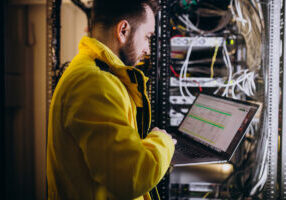 A network engineer configuring an ALPR system used in an ultimate guide to ALPR implementation and also an article on ALPR labor costs