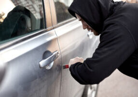 LPR in law enforcement: A man in a black hoodie trying to break into a parked car